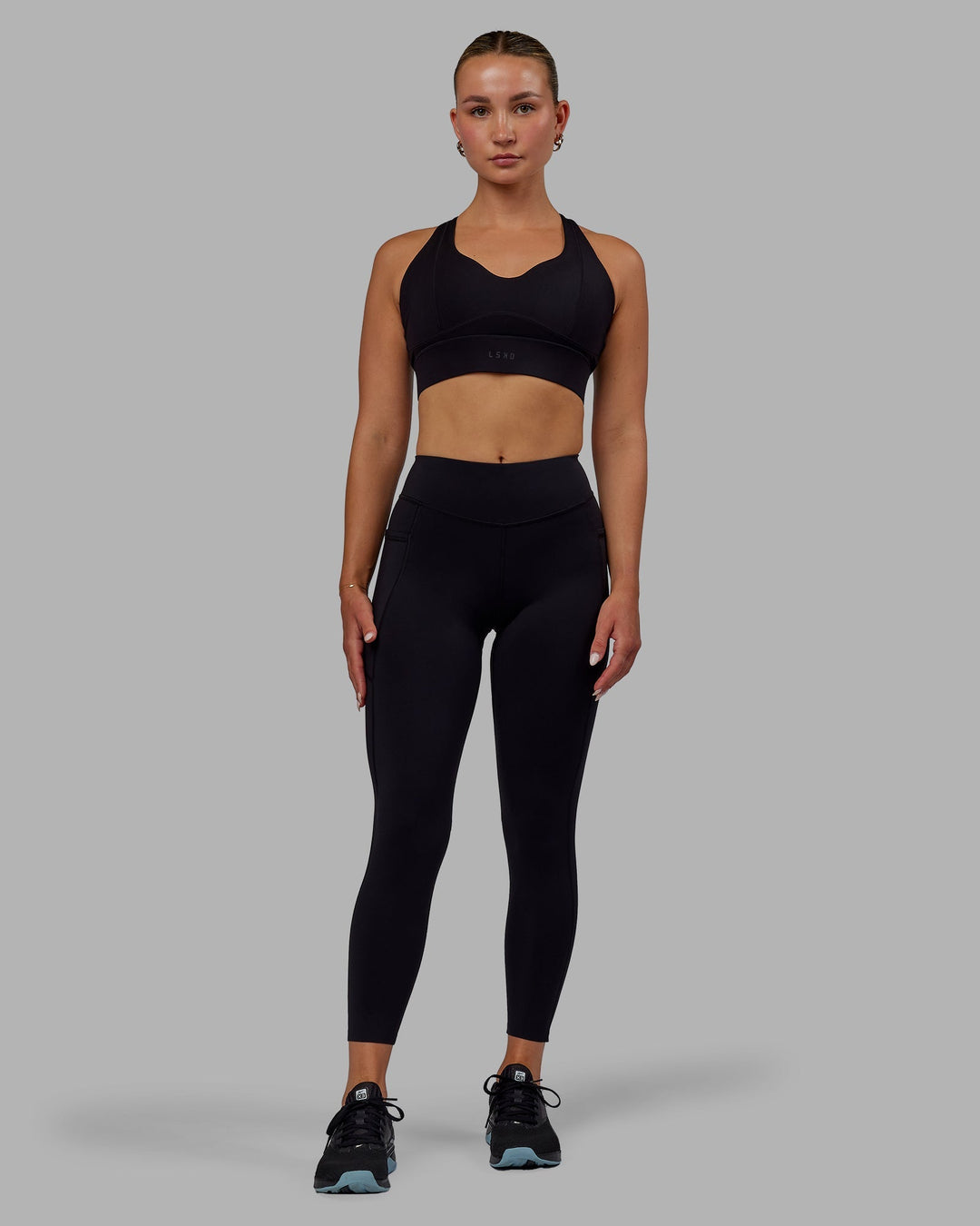 Woman wearing Elite High-Rise 7/8 Legging Pockets - Black