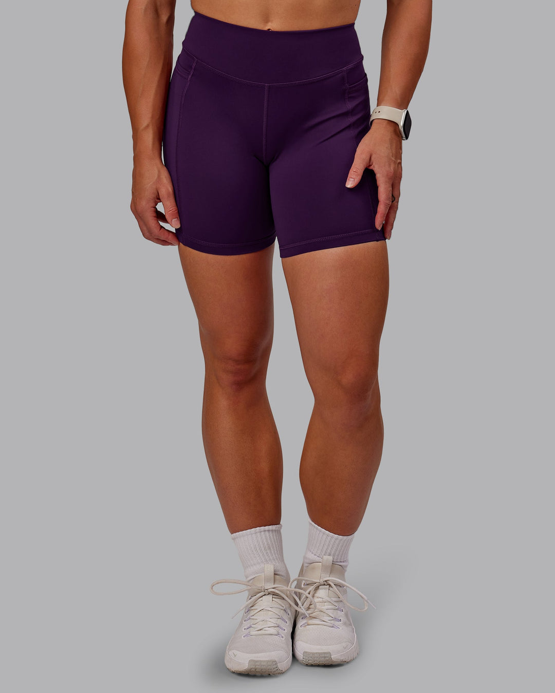 Woman wearing Elite High-Rise 6" Short Pockets in Deep Purple | Size:S