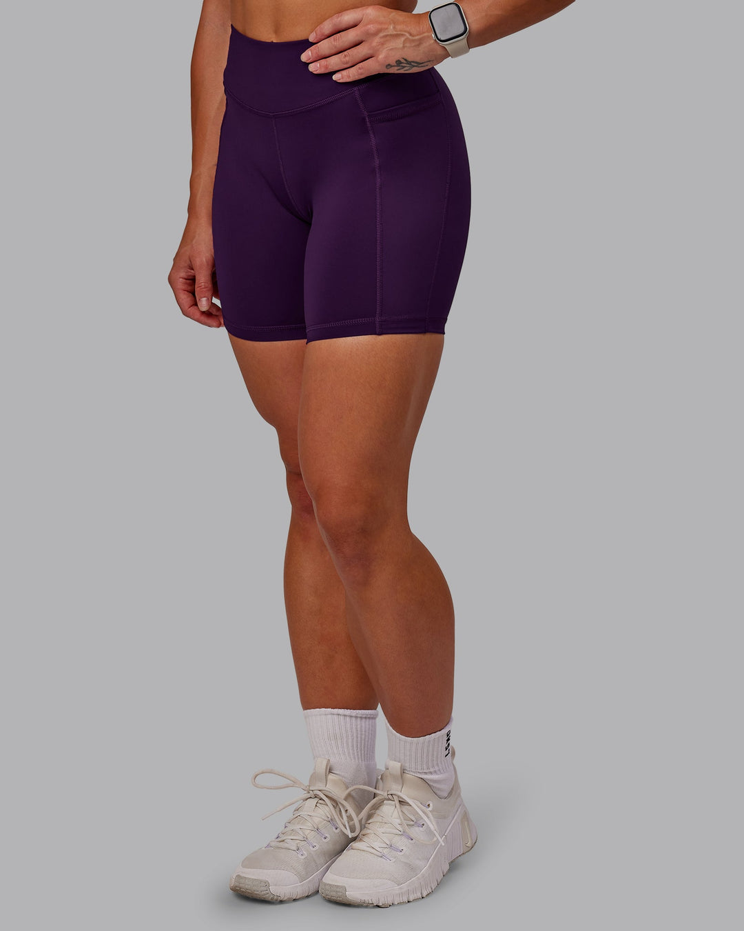 Woman wearing Elite High-Rise 6" Short Pockets in Deep Purple | Size:S