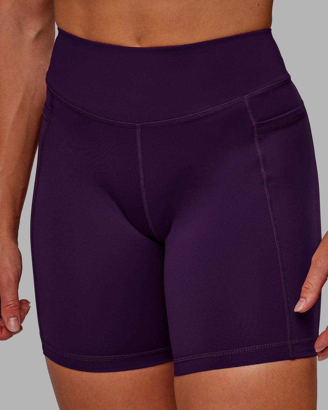 Woman wearing Elite High-Rise 6" Short Pockets in Deep Purple | Size:S