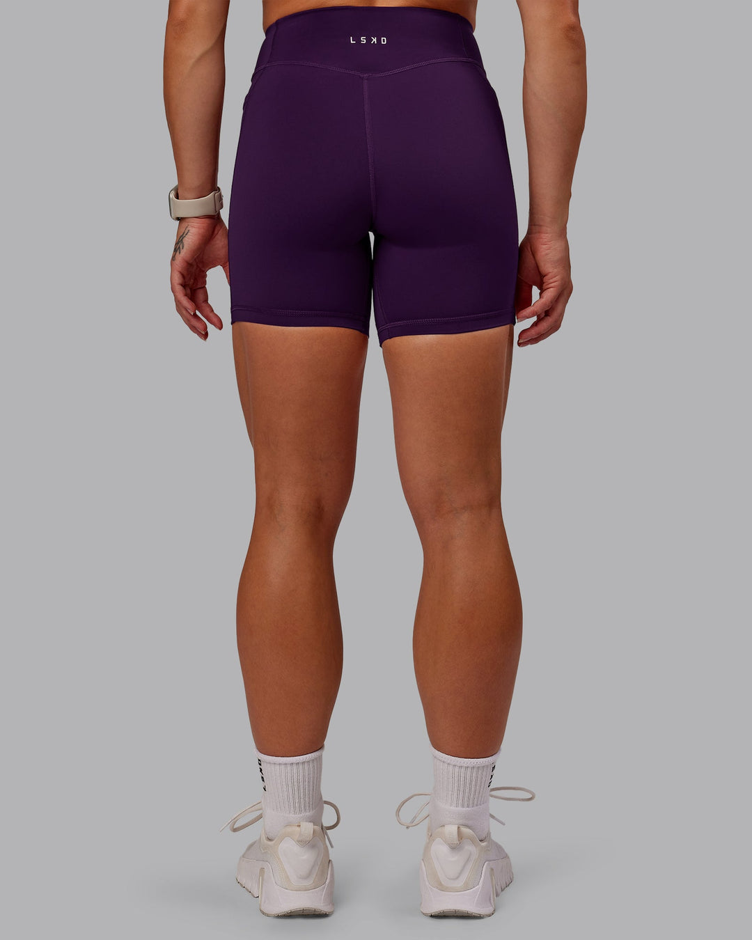Woman wearing Elite High-Rise 6" Short Pockets in Deep Purple | Size:S