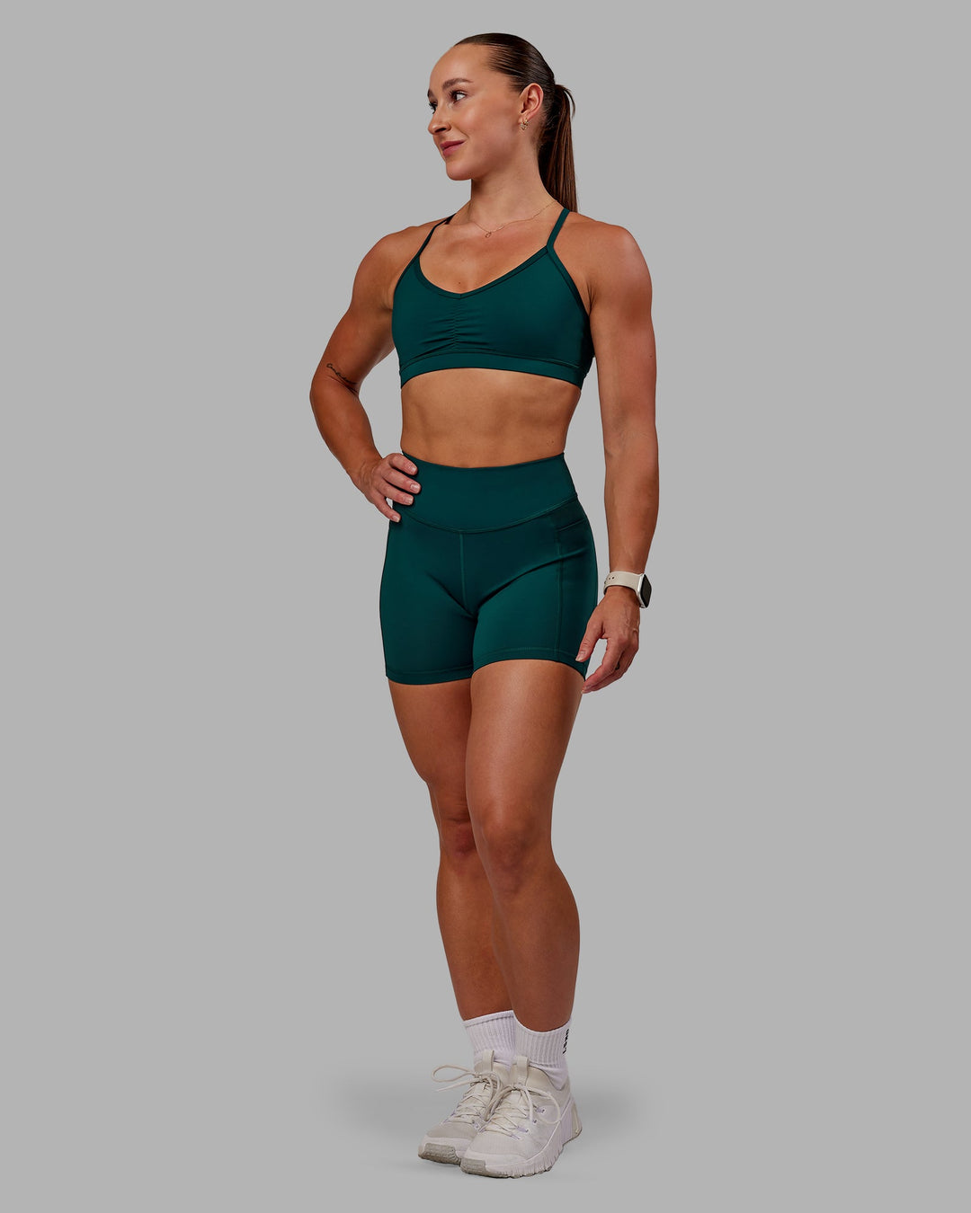 Woman wearing Elite High-Rise 4" Short Pockets - Dark Moss| Size:S