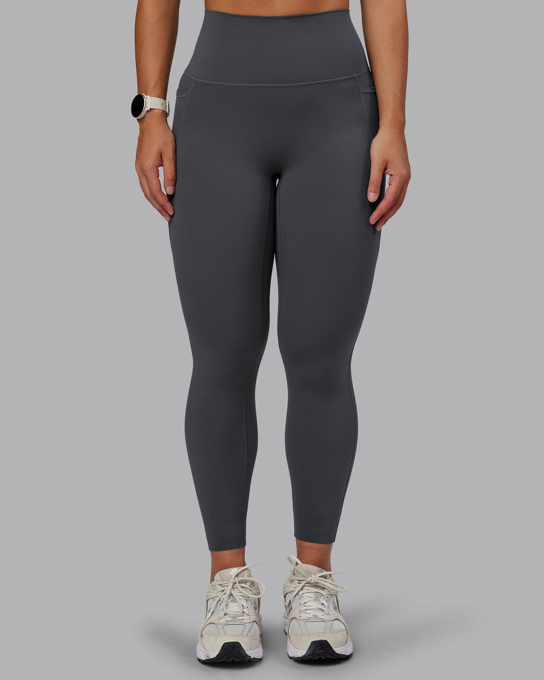 Woman wearing Elixir Ultra High-Rise 7/8 Legging Pockets in Dark Storm | Size:S