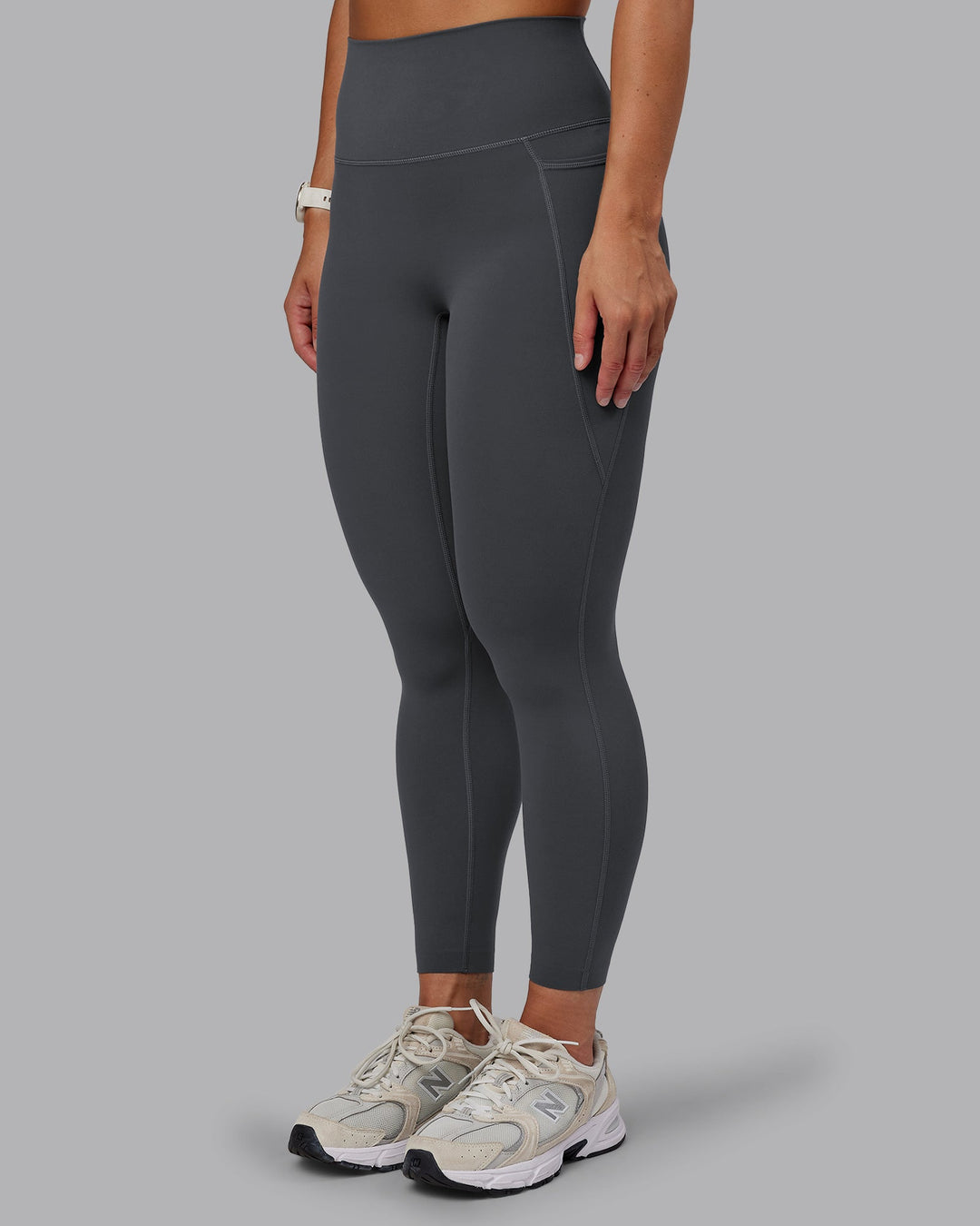 Woman wearing Elixir Ultra High-Rise 7/8 Legging Pockets in Dark Storm | Size:S