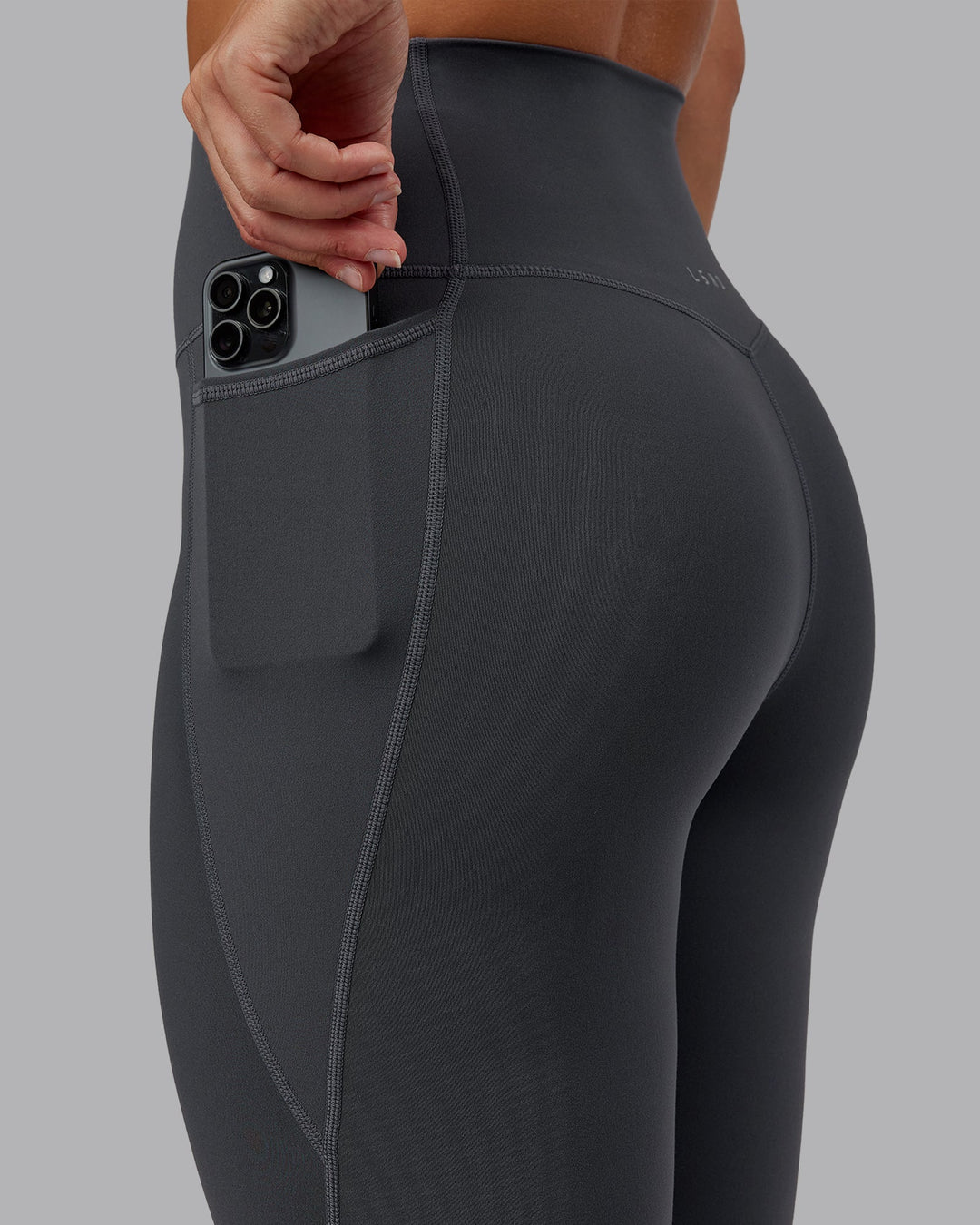 Woman wearing Elixir Ultra High-Rise 7/8 Legging Pockets in Dark Storm | Size:S