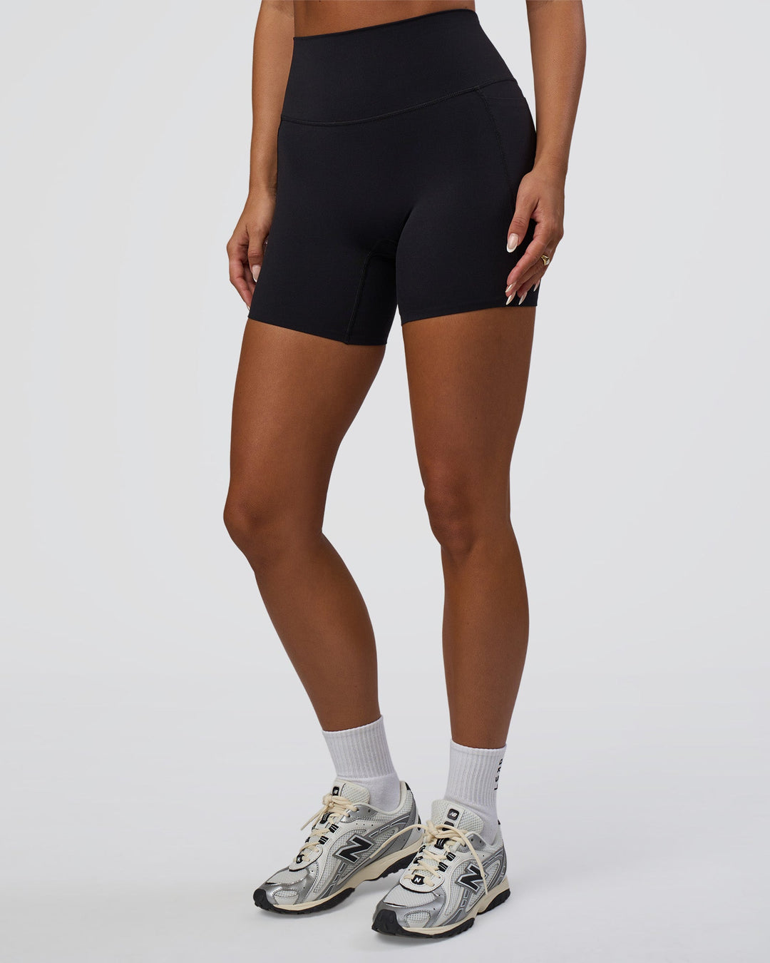 Woman wearing Elixir Defined High-Rise 6" Short Pockets - Black | Model:Bianca | Size:S