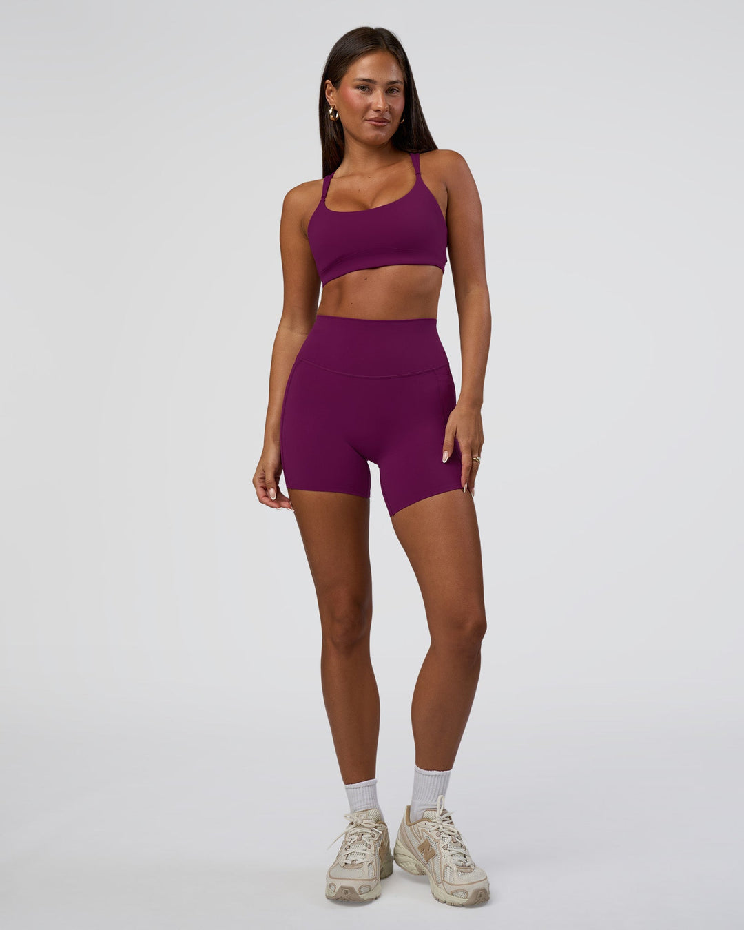 Woman wearing Elixir Defined High-Rise 6" Short Pockets - Plum Caspia | Model:Bianca | Size:S