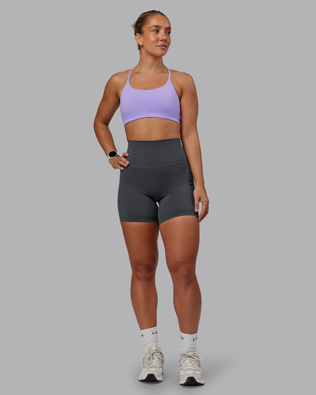Woman wearing Elixir Ultra High-Rise 6" Short Pockets in Dark Storm | Size:S