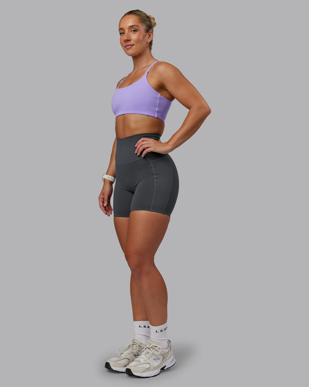 Woman wearing Elixir Ultra High-Rise 6" Short Pockets in Dark Storm | Size:S