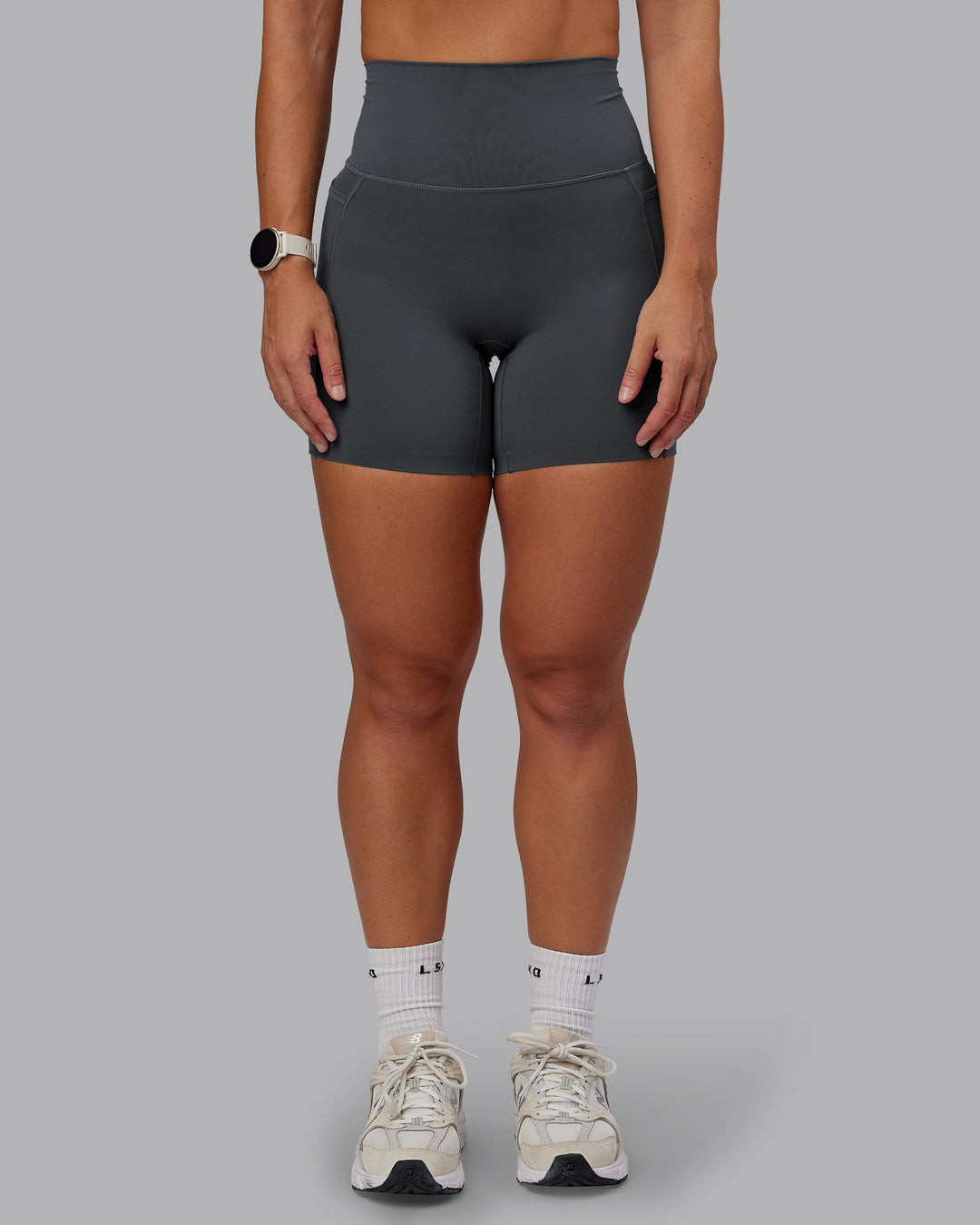 Woman wearing Elixir Ultra High-Rise 6" Short Pockets in Dark Storm | Size:S