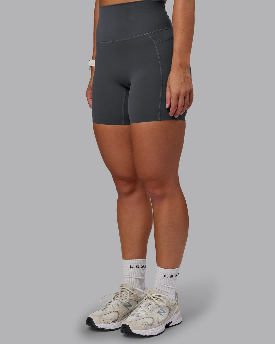 Woman wearing Elixir Ultra High-Rise 6" Short Pockets in Dark Storm | Size:S