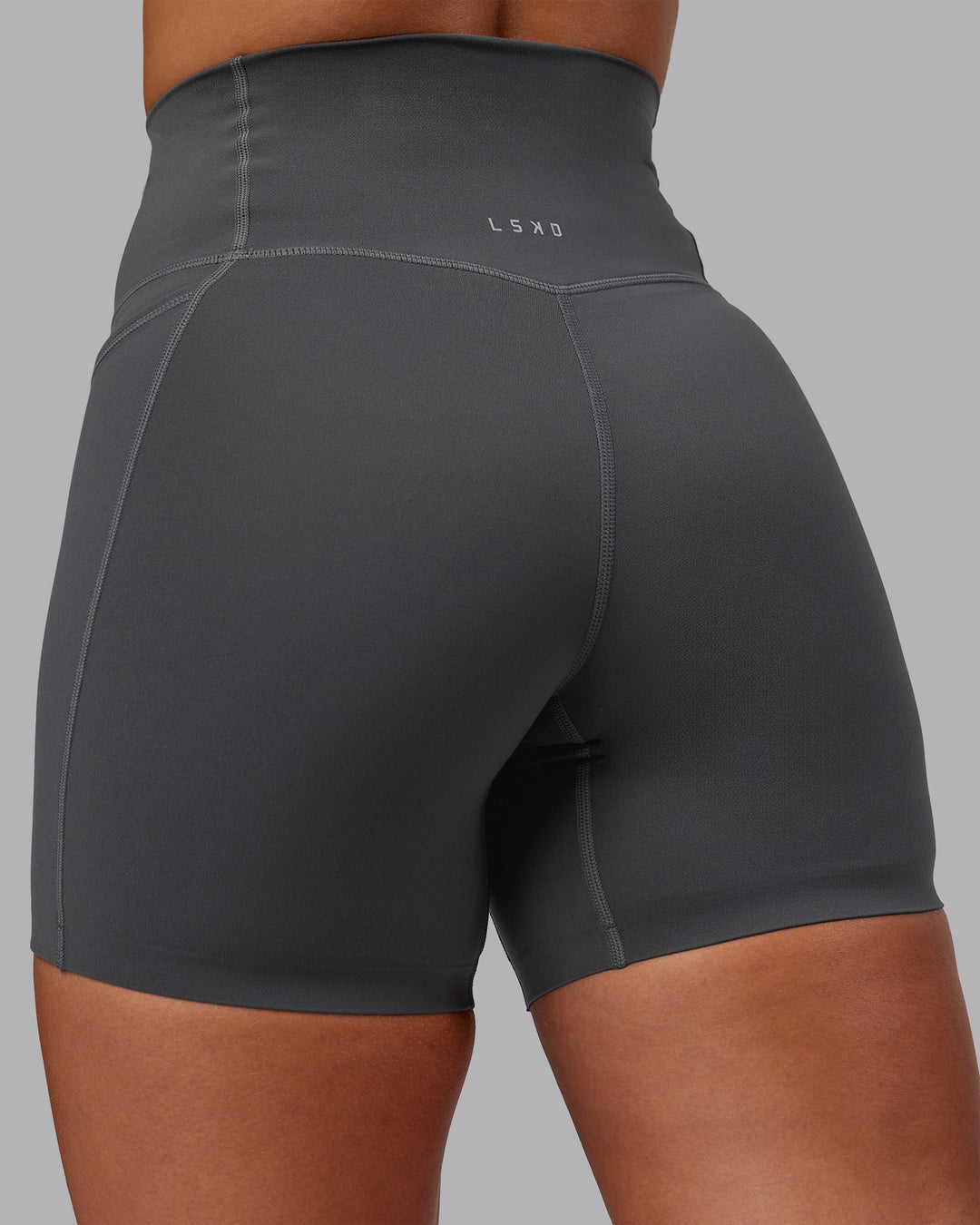 Woman wearing Elixir Ultra High-Rise 6" Short Pockets in Dark Storm | Size:S