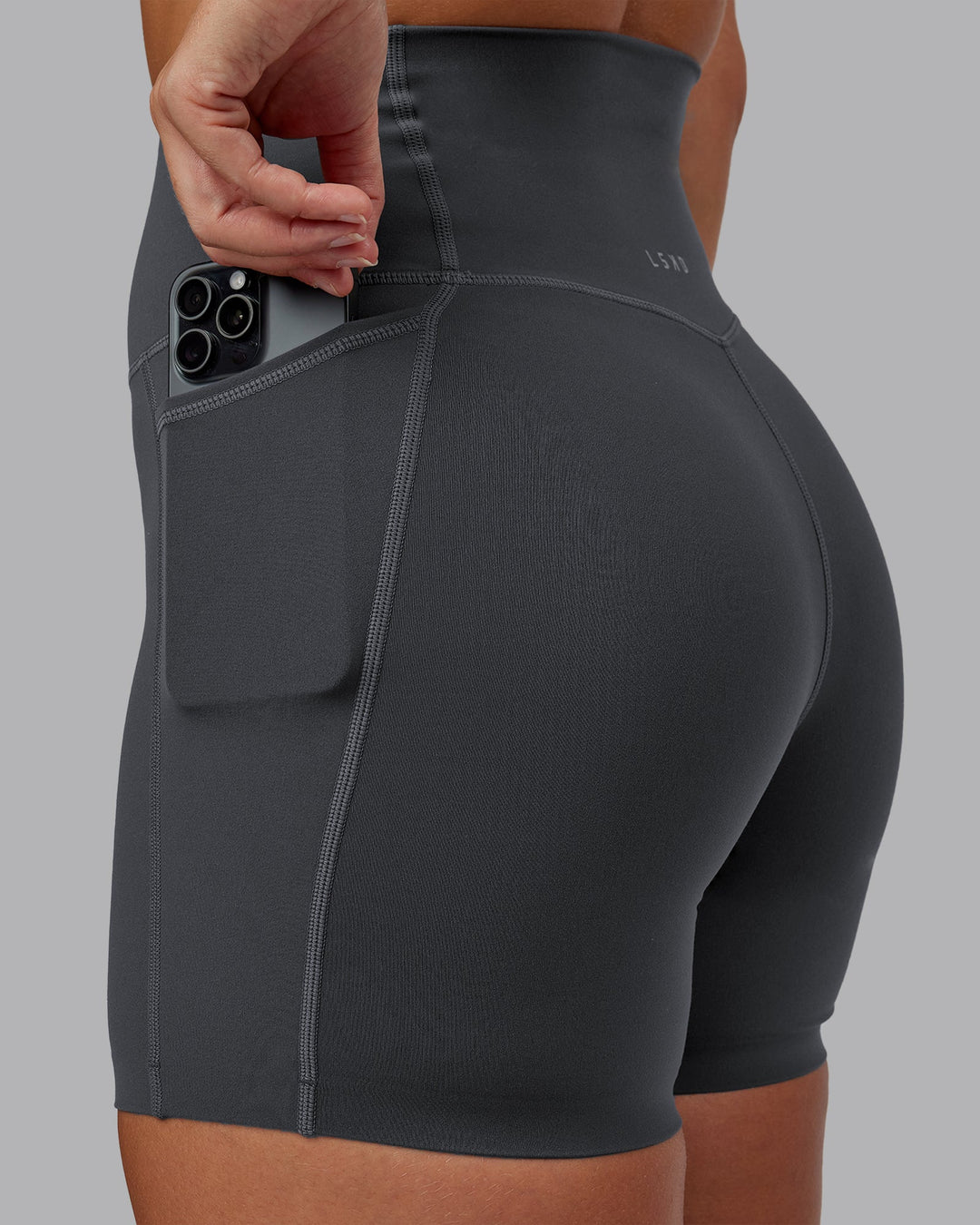 Woman wearing Elixir Ultra High-Rise 6" Short Pockets in Dark Storm | Size:S