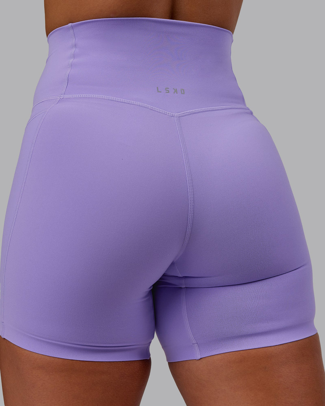 Woman wearing Elixir Ultra High-Rise 6" Short Pockets in Violet Ray | Size:S