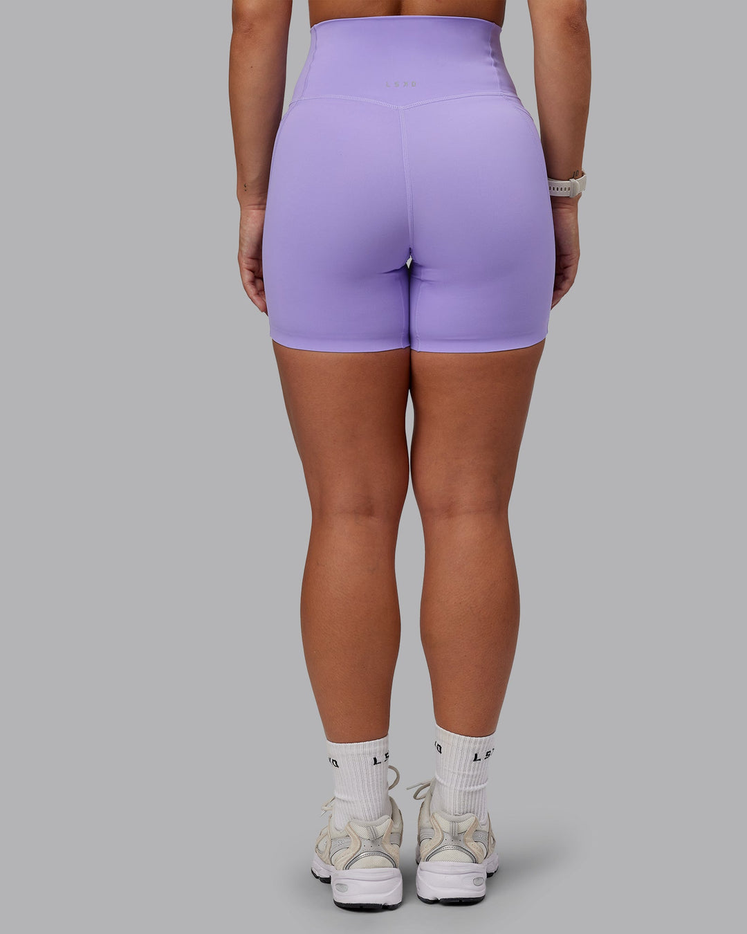 Woman wearing Elixir Ultra High-Rise 6" Short Pockets in Violet Ray | Size:S