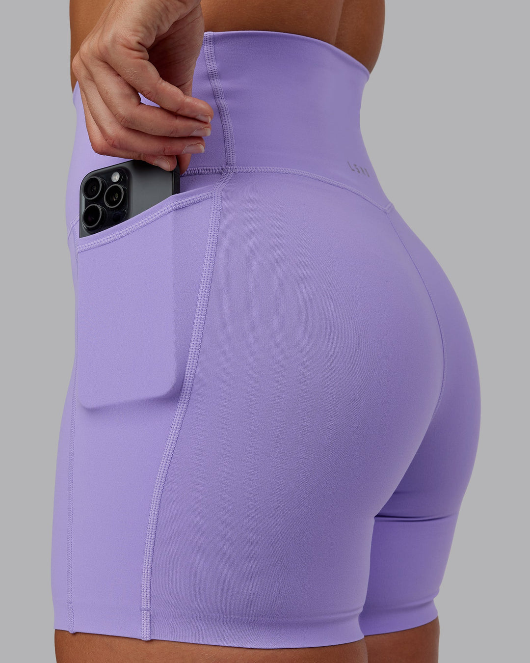 Woman wearing Elixir Ultra High-Rise 6" Short Pockets in Violet Ray | Size:S