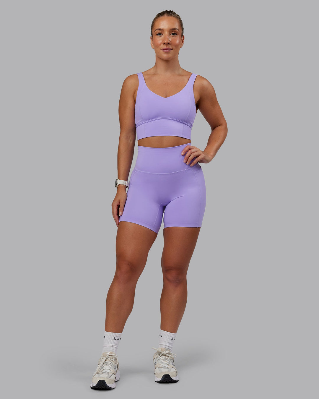Woman wearing Elixir Ultra High-Rise 6" Short Pockets in Violet Ray | Size:S
