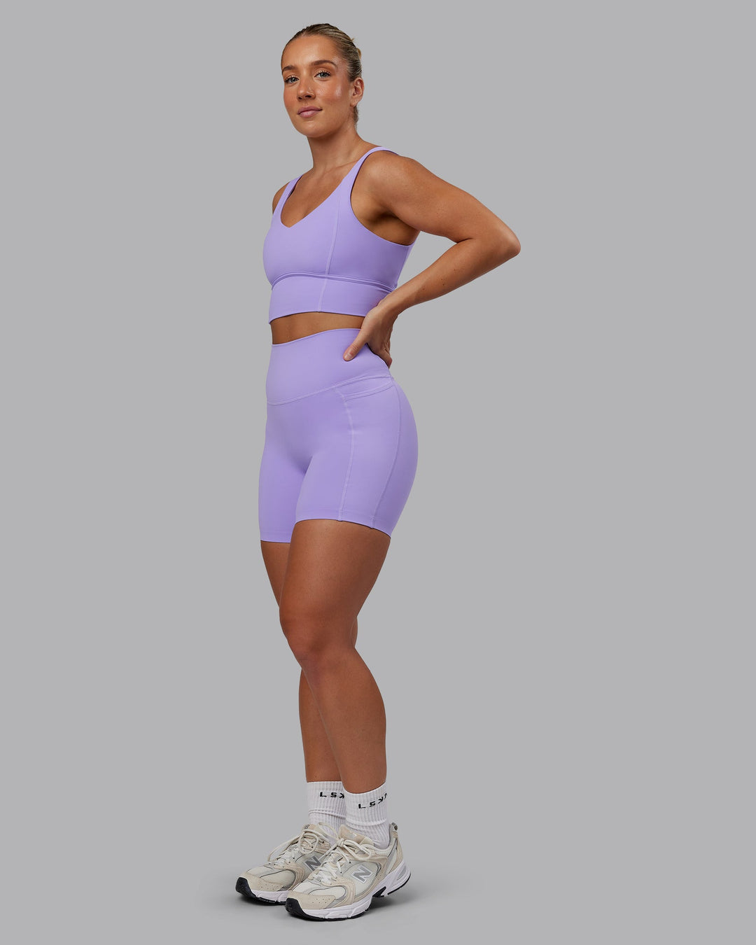Woman wearing Elixir Ultra High-Rise 6" Short Pockets in Violet Ray | Size:S