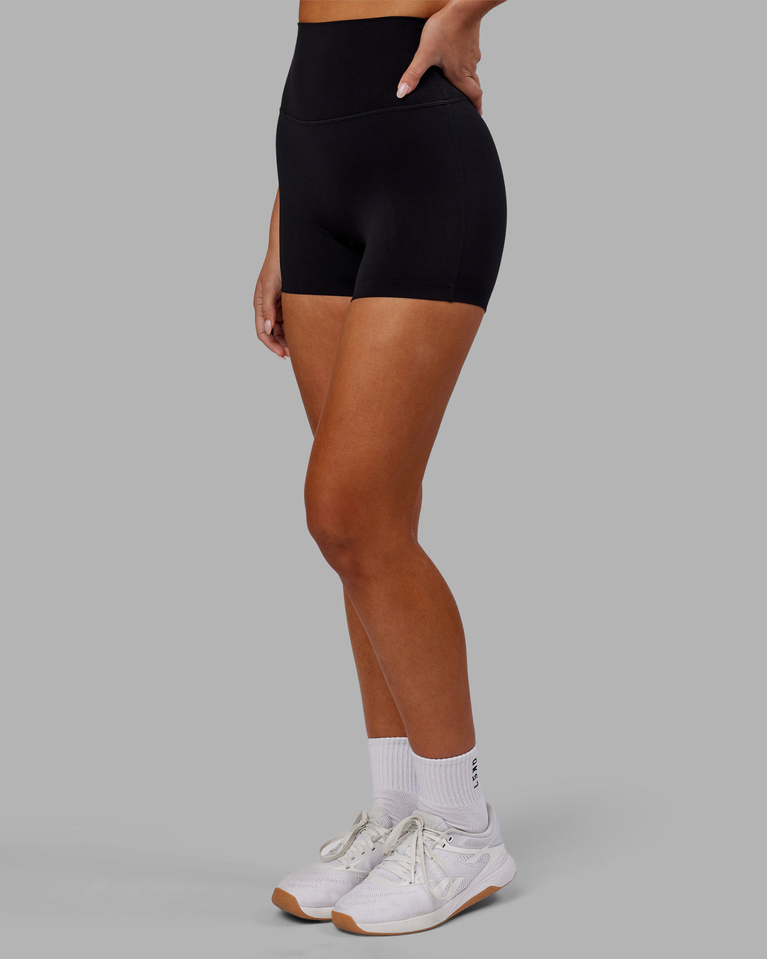 Woman wearing Elixir Ultra High-Rise 4" Short - Black | Model:Kirstyn | Size:S