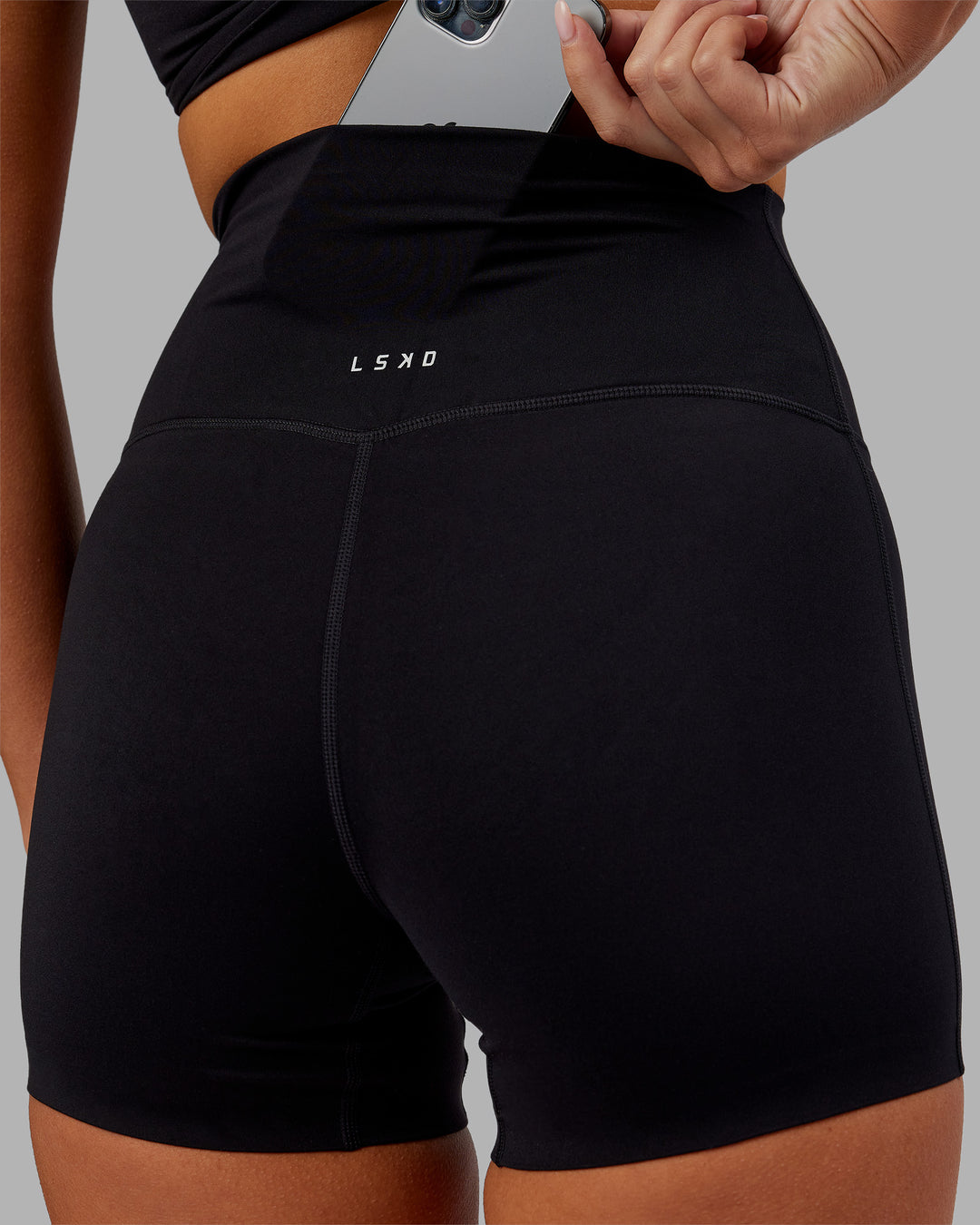 Woman wearing Elixir Ultra High-Rise 4" Short - Black | Model:Kirstyn | Size:S