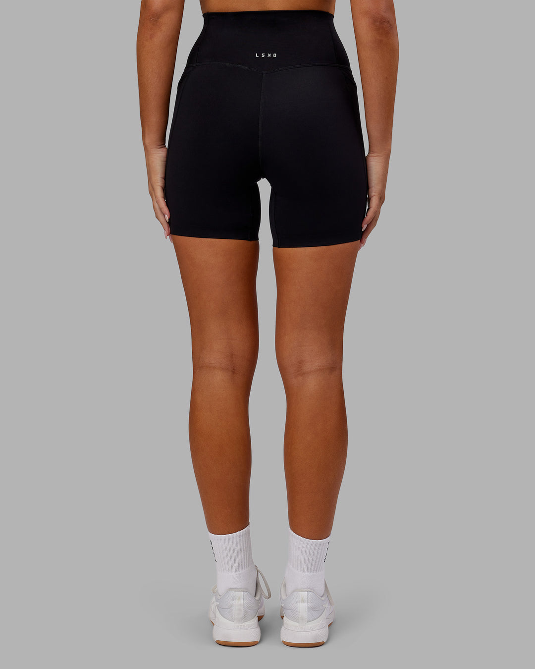 Woman wearing Elixir Ultra High-Rise 6" Short Pockets - Black | Model:Kirstyn | Size:S