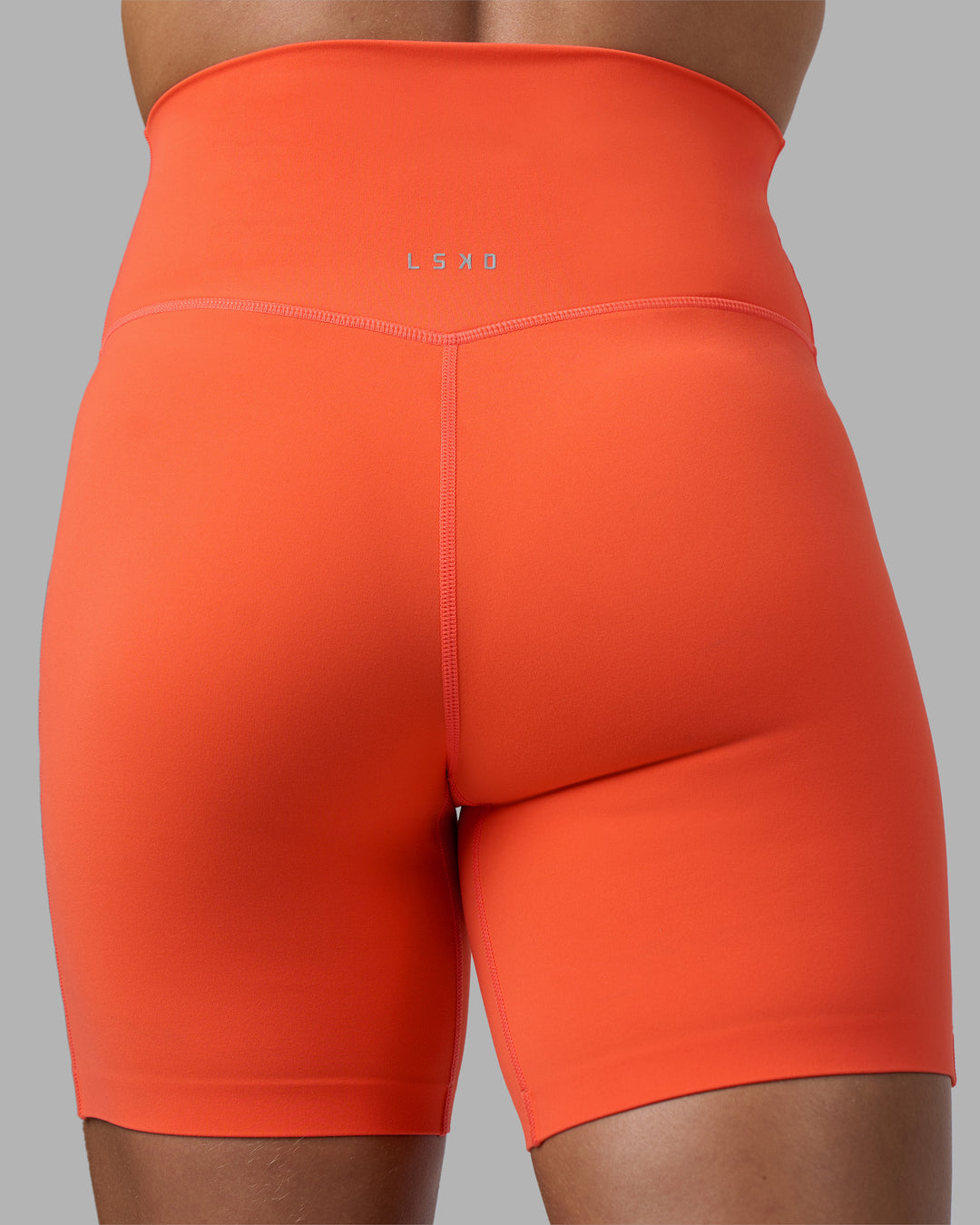 Woman wearing Elixir Ultra High-Rise 6" Short - Ultra Orange | Model:Katie | Size:S