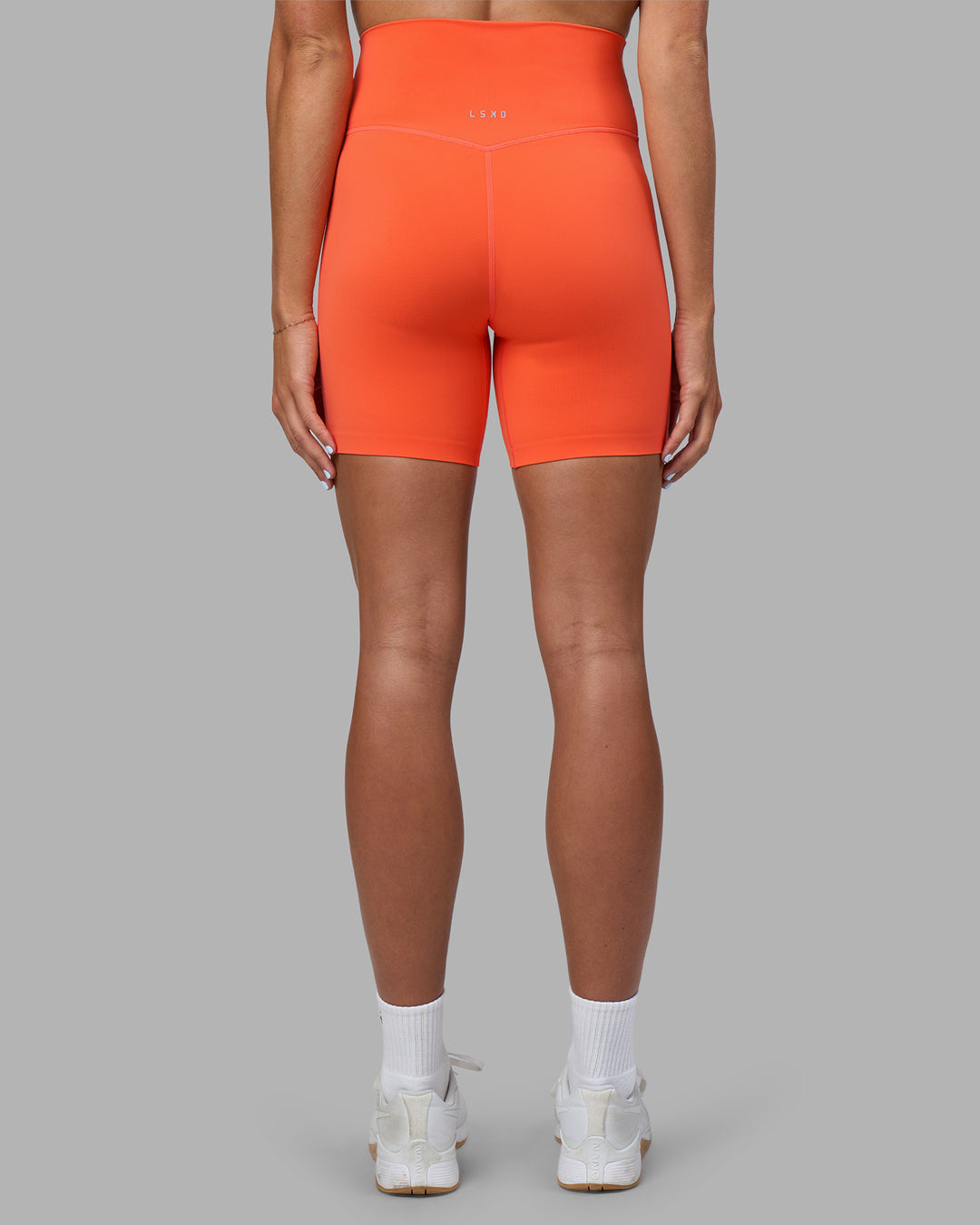 Woman wearing Elixir Ultra High-Rise 6" Short - Ultra Orange | Model:Katie | Size:S