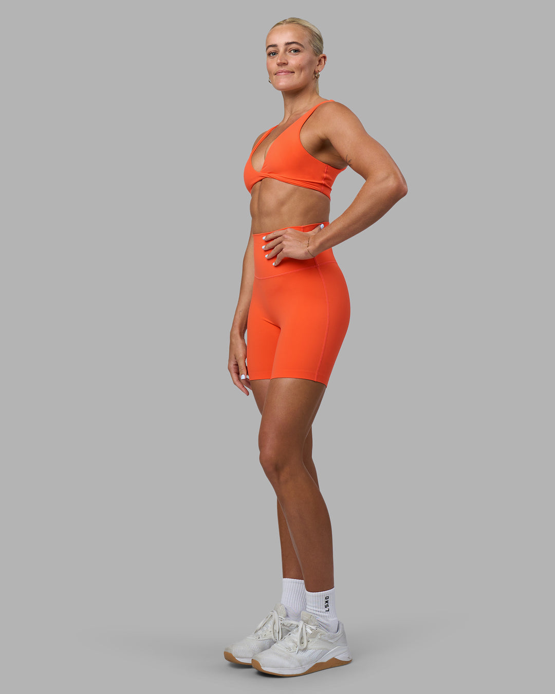 Woman wearing Elixir Ultra High-Rise 6" Short - Ultra Orange | Model:Katie | Size:S