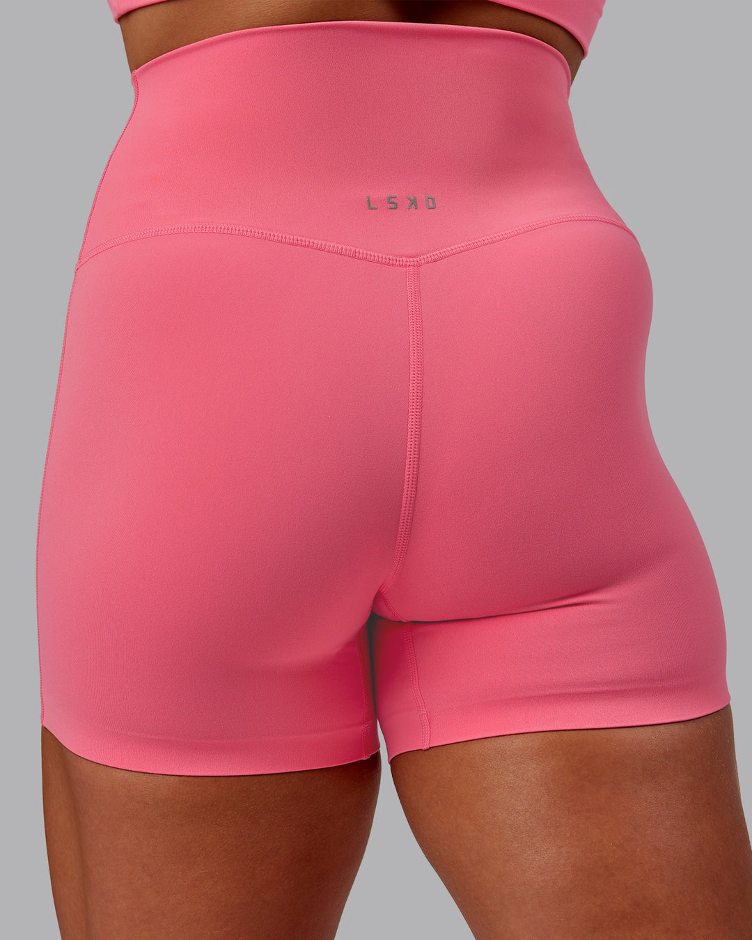Woman wearing Elixir Ultra High-Rise 4" Short in Pink Lemonade | Size:S