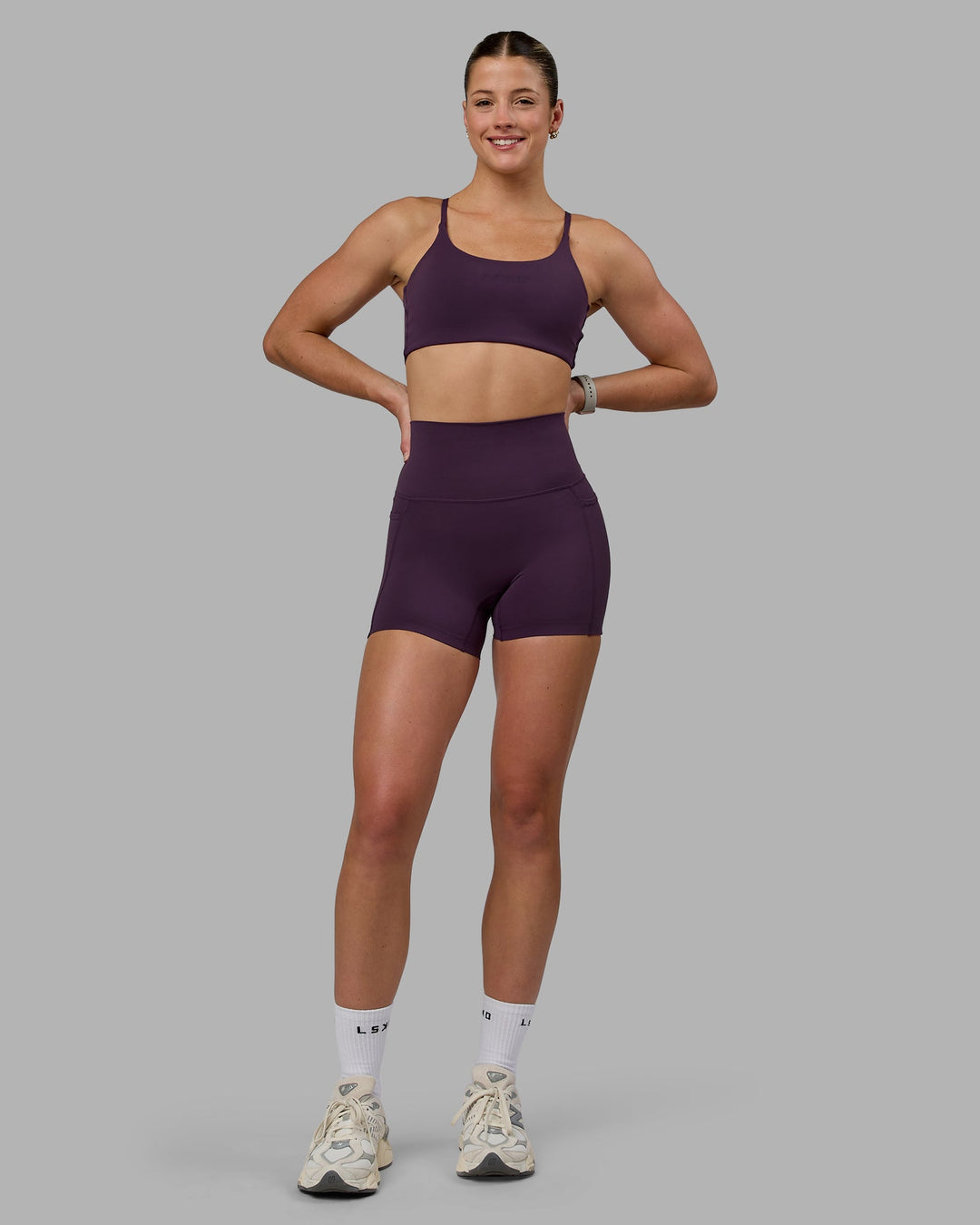 Woman wearing Elixir Ultra High-Rise 4" Short Pockets - Midnight Plum