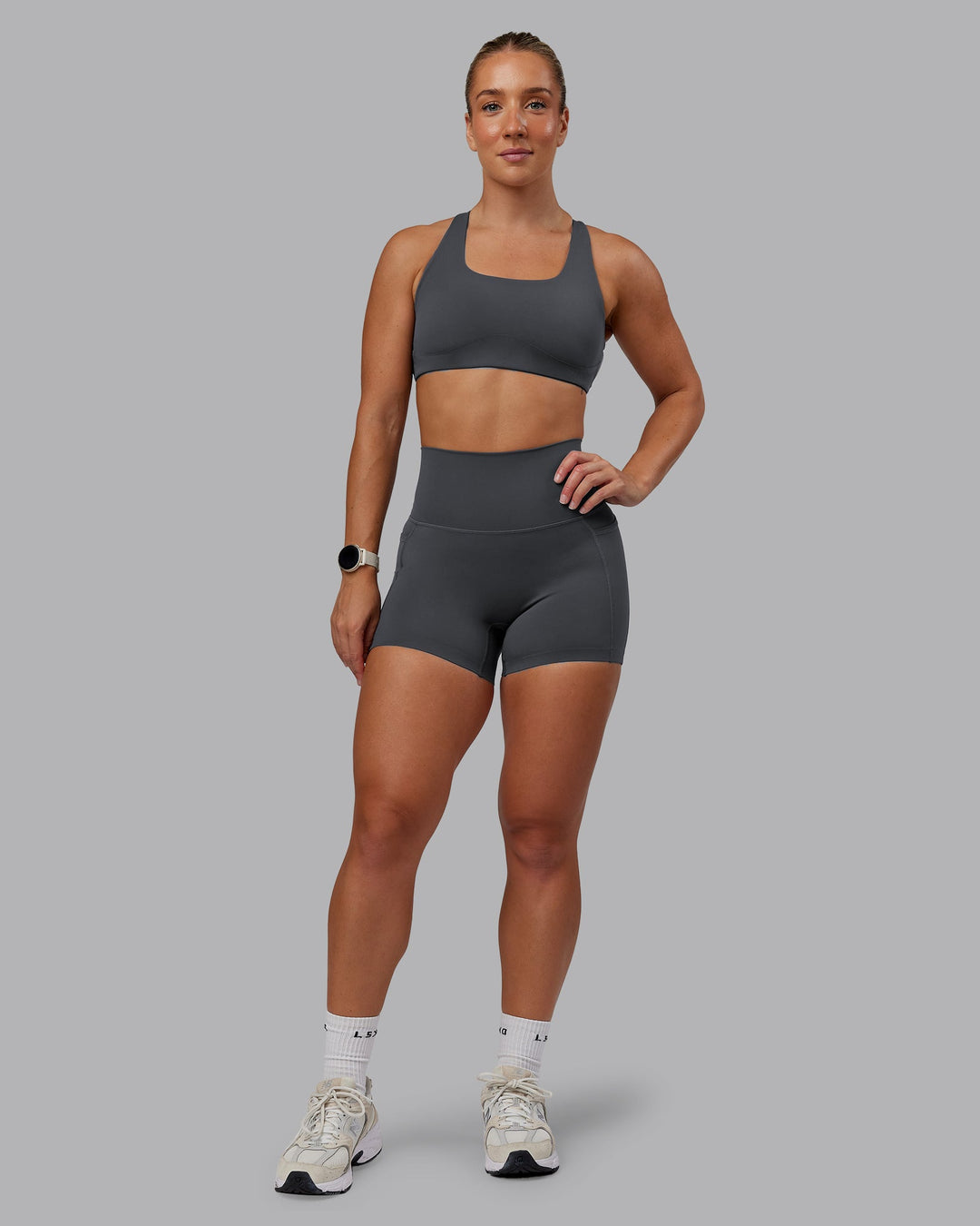 Woman wearing Elixir Ultra High-Rise 4" Short Pockets in Dark Storm | Size:S