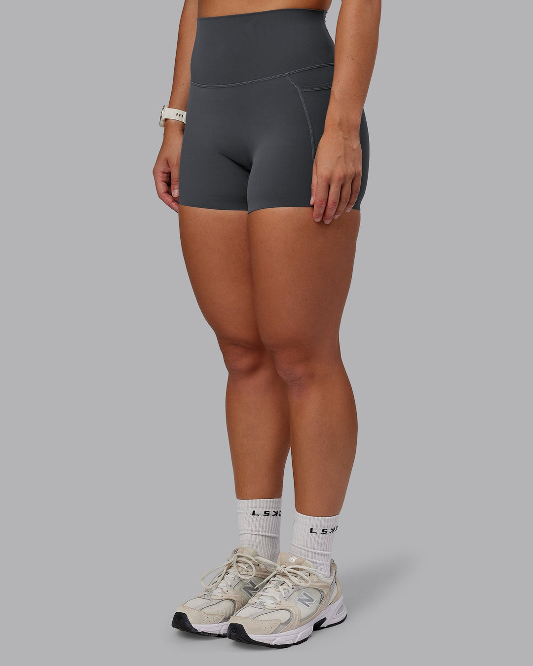 Woman wearing Elixir Ultra High-Rise 4" Short Pockets in Dark Storm | Size:S