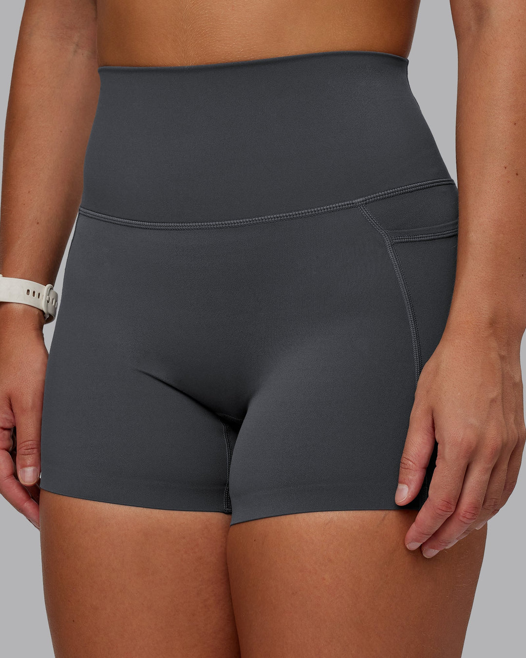 Woman wearing Elixir Ultra High-Rise 4" Short Pockets in Dark Storm | Size:S