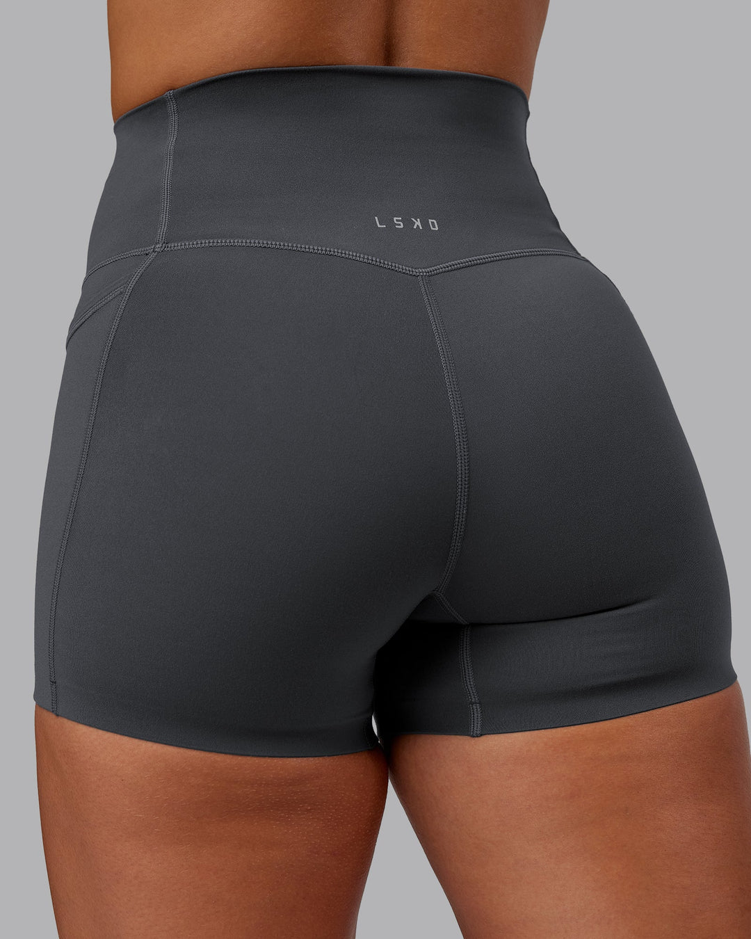 Woman wearing Elixir Ultra High-Rise 4" Short Pockets in Dark Storm | Size:S