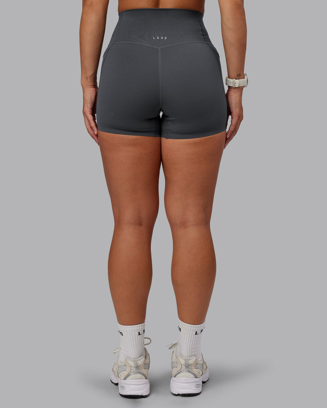 Woman wearing Elixir Ultra High-Rise 4" Short Pockets in Dark Storm | Size:S