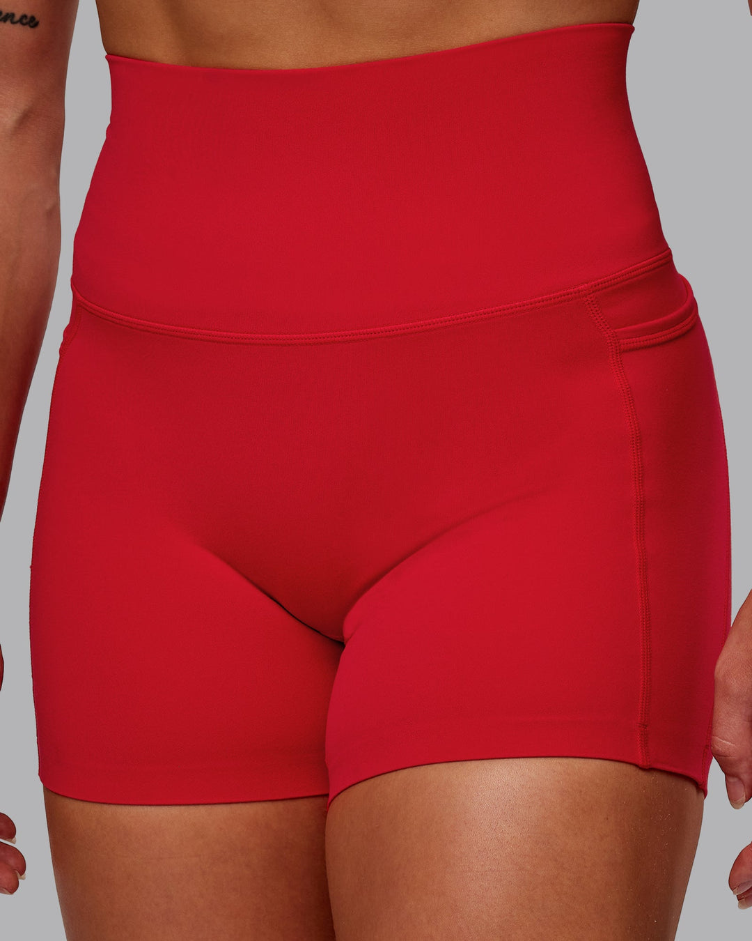 Woman wearing Elixir Ultra High-Rise 4" Short Pockets in Flame | Size:S