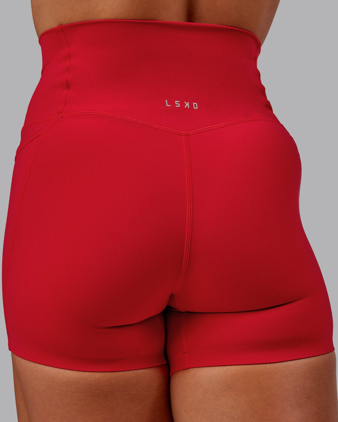 Woman wearing Elixir Ultra High-Rise 4" Short Pockets in Flame | Size:S
