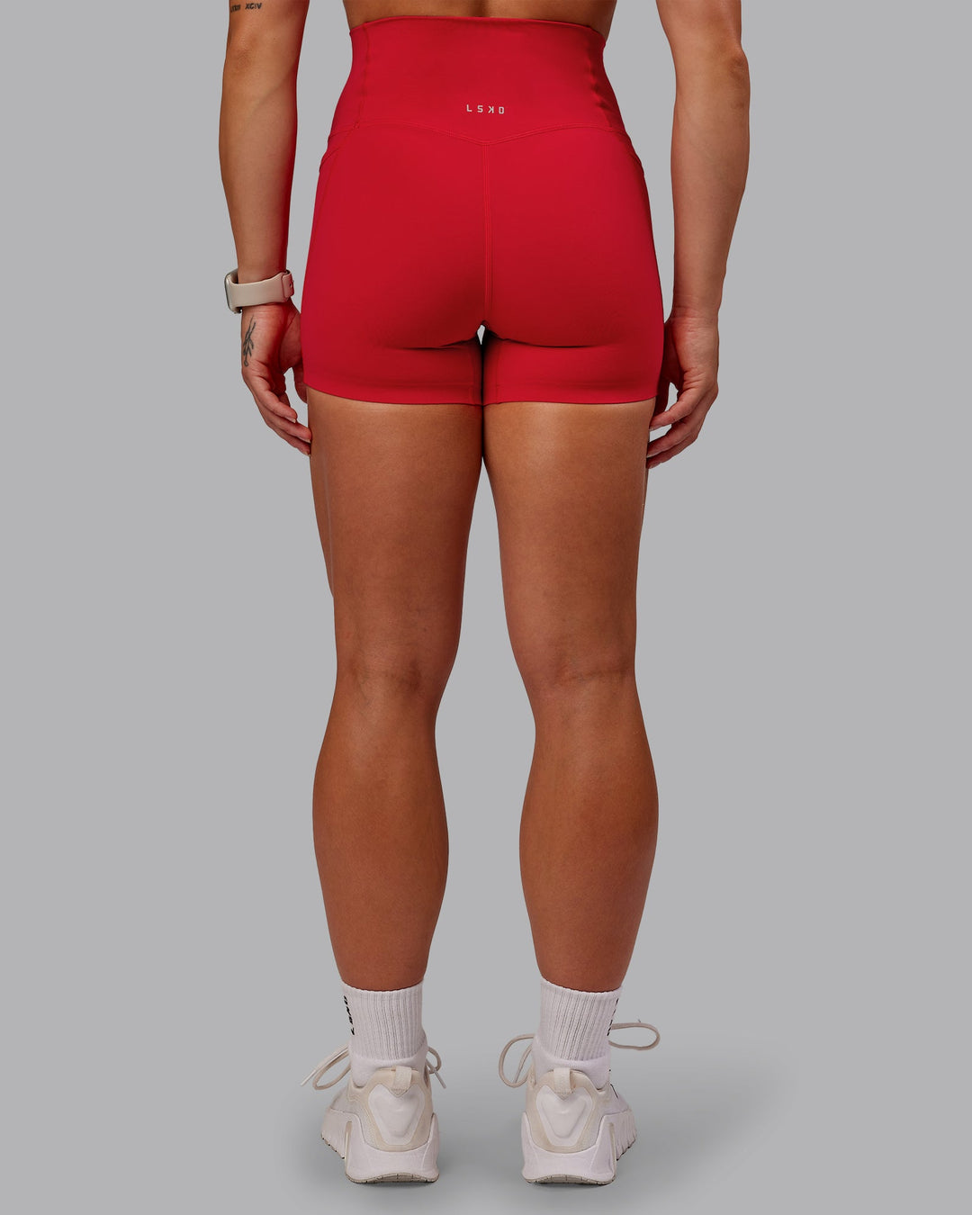 Woman wearing Elixir Ultra High-Rise 4" Short Pockets in Flame | Size:S