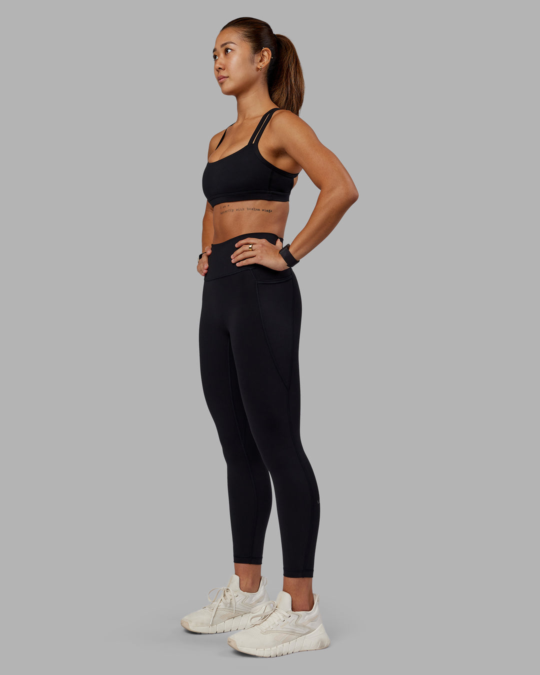 Woman wearing Fusion Ultra High-Rise 7/8 Legging Pockets - Black | Model:Vanessa | Size:S