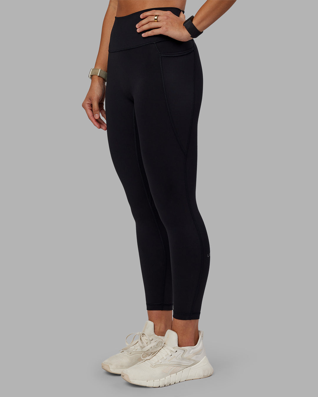 Woman wearing Fusion Ultra High-Rise 7/8 Legging Pockets - Black | Model:Vanessa | Size:S