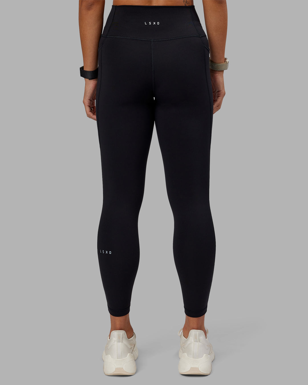 Woman wearing Fusion Ultra High-Rise 7/8 Legging Pockets - Black | Model:Vanessa | Size:S