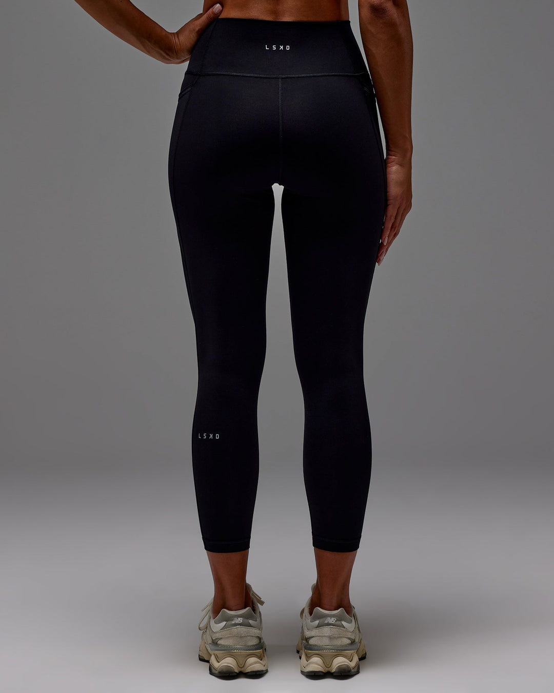 Woman wearing Fusion Ultra High-Rise 7/8 Legging Pockets - Black | Model:Demi | Size:S