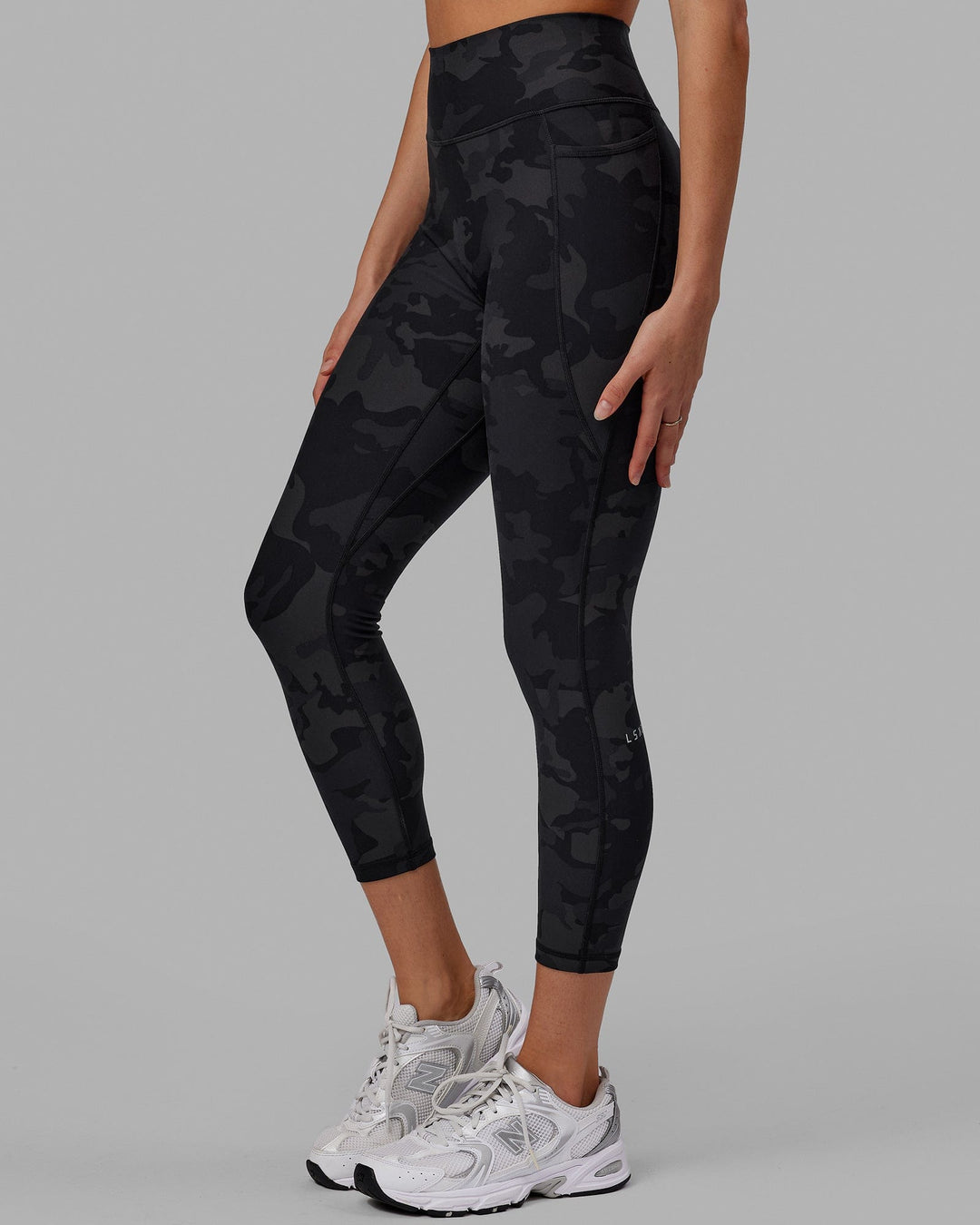 Woman wearing Fusion Ultra High-Rise 7/8 Legging Pockets - Black-Camo | Model:Katie | Size:S