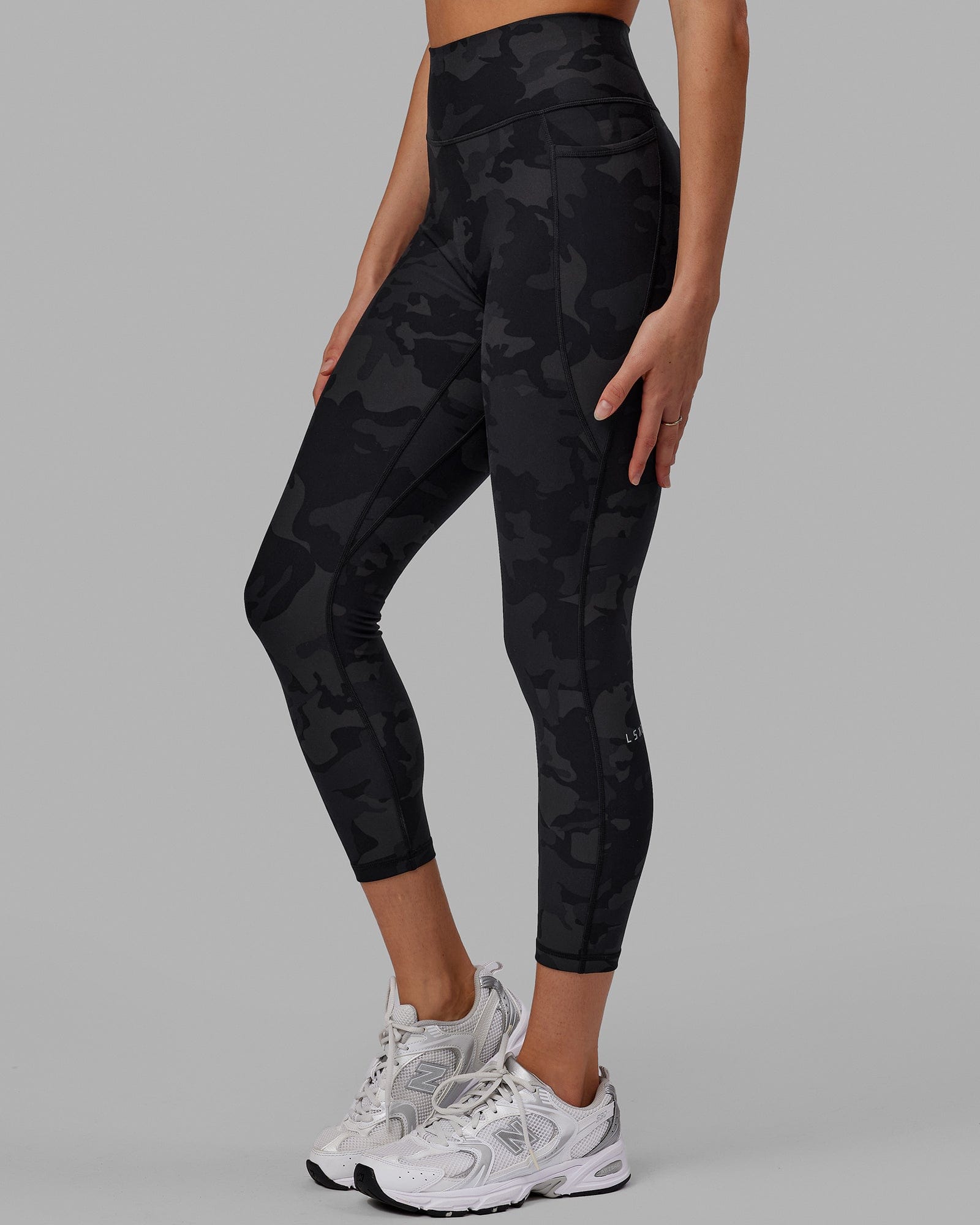 Woman wearing Fusion Ultra High-Rise 7/8 Legging Pockets - Black-Camo | Model:Katie | Size:S