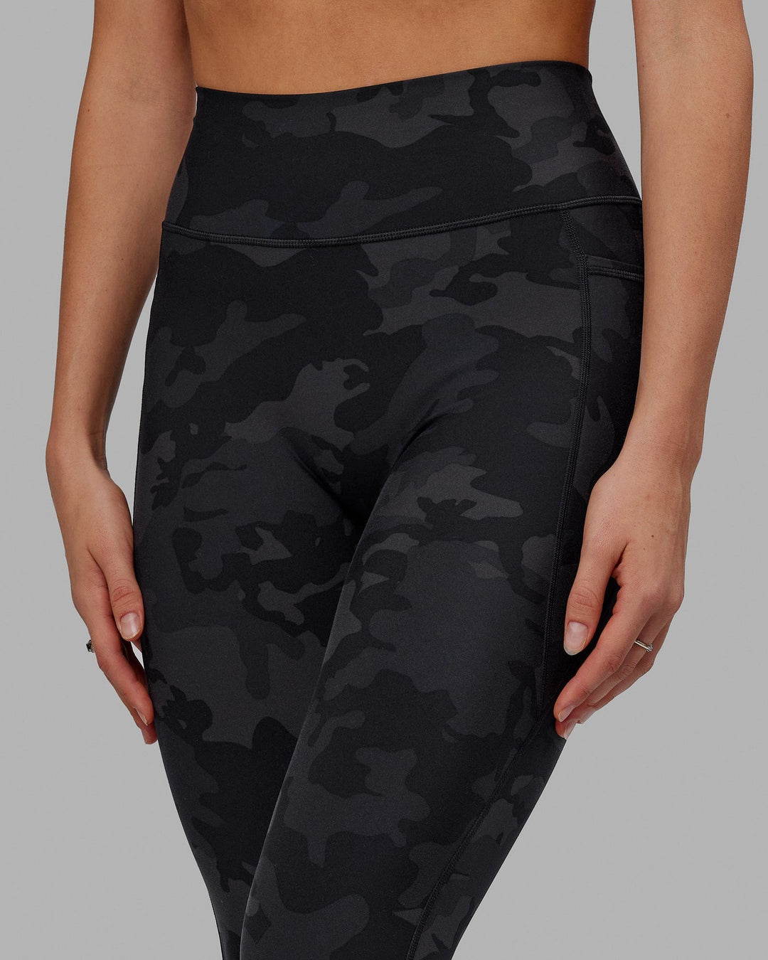 Woman wearing Fusion Ultra High-Rise 7/8 Legging Pockets - Black-Camo | Model:Katie | Size:S