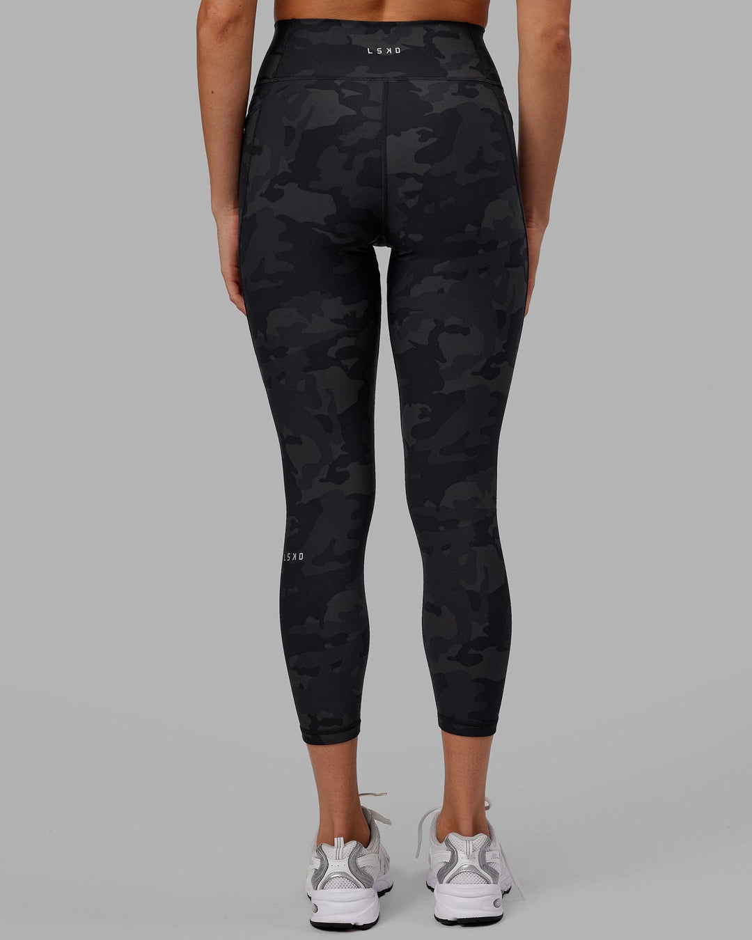 Woman wearing Fusion Ultra High-Rise 7/8 Legging Pockets - Black-Camo | Model:Katie | Size:S