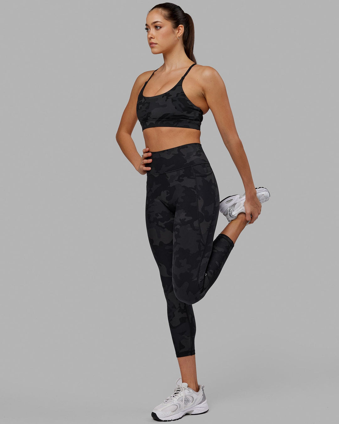Woman wearing Fusion Ultra High-Rise 7/8 Legging Pockets - Black-Camo | Model:Katie | Size:S