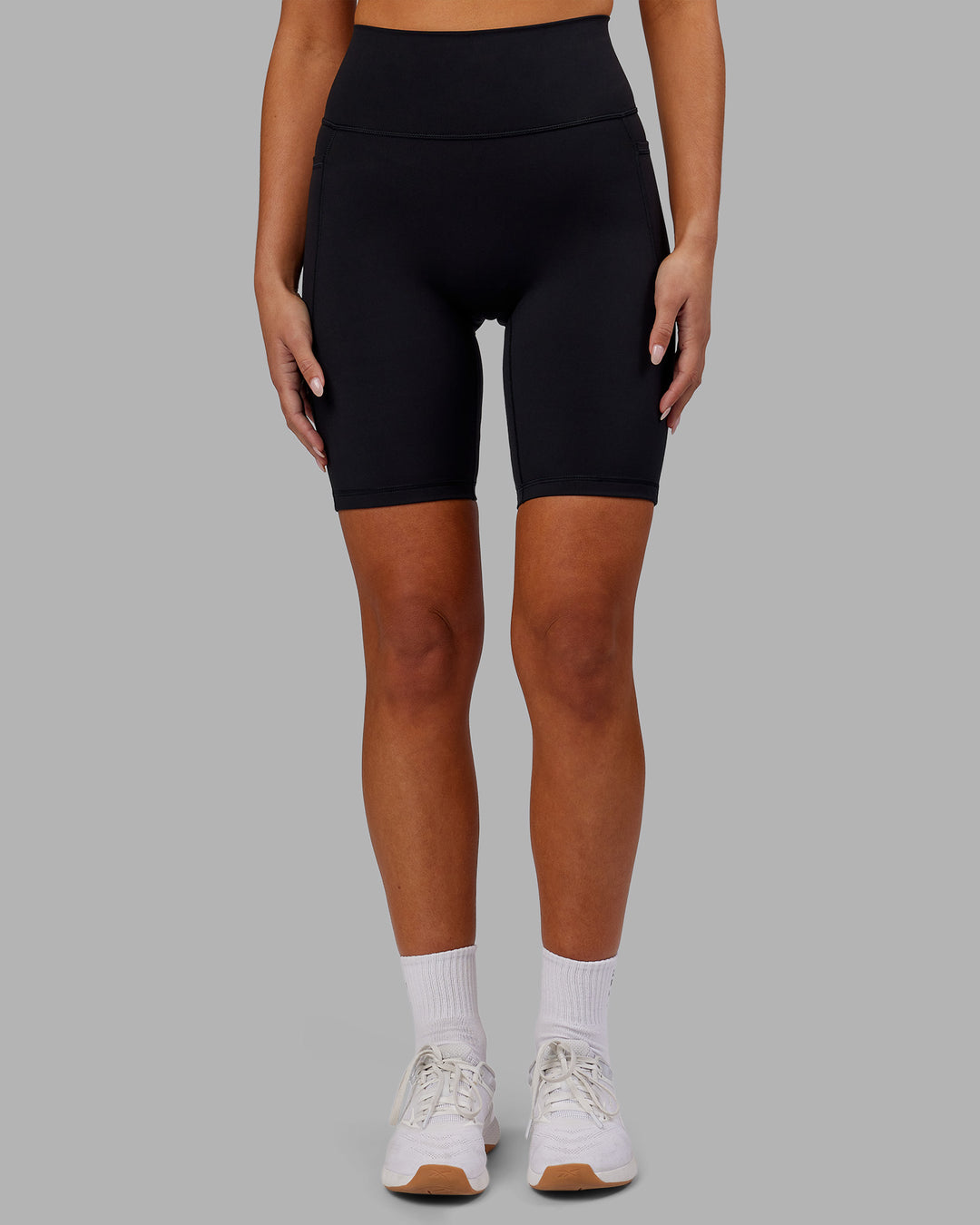 Woman wearing Fusion Ultra High-Rise 9" Short Pockets - Black | Model:Kirstyn | Size:S