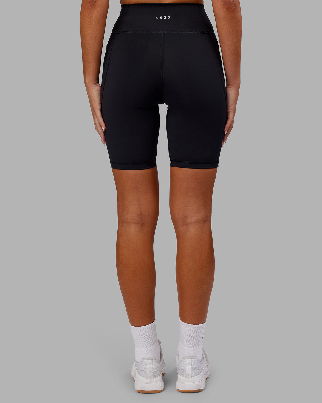 Woman wearing Fusion Ultra High-Rise 9" Short Pockets - Black | Model:Kirstyn | Size:S