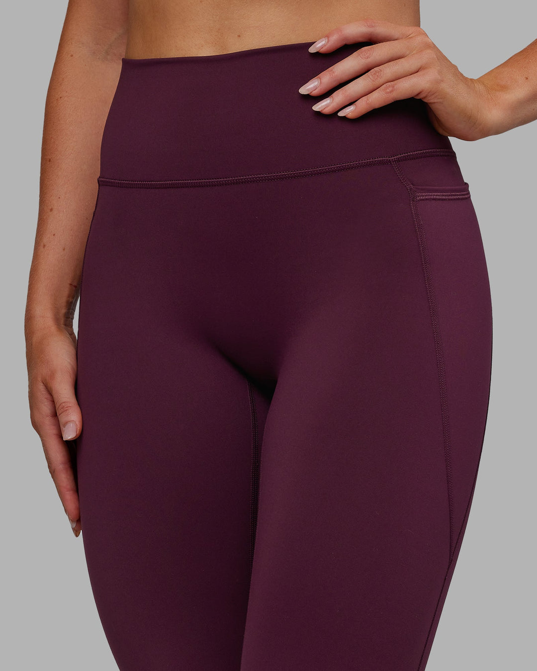 Woman wearing Fusion Ultra High-Rise Full Length Legging Pockets - Cherry Lacquer | Model:Paris | Size:S